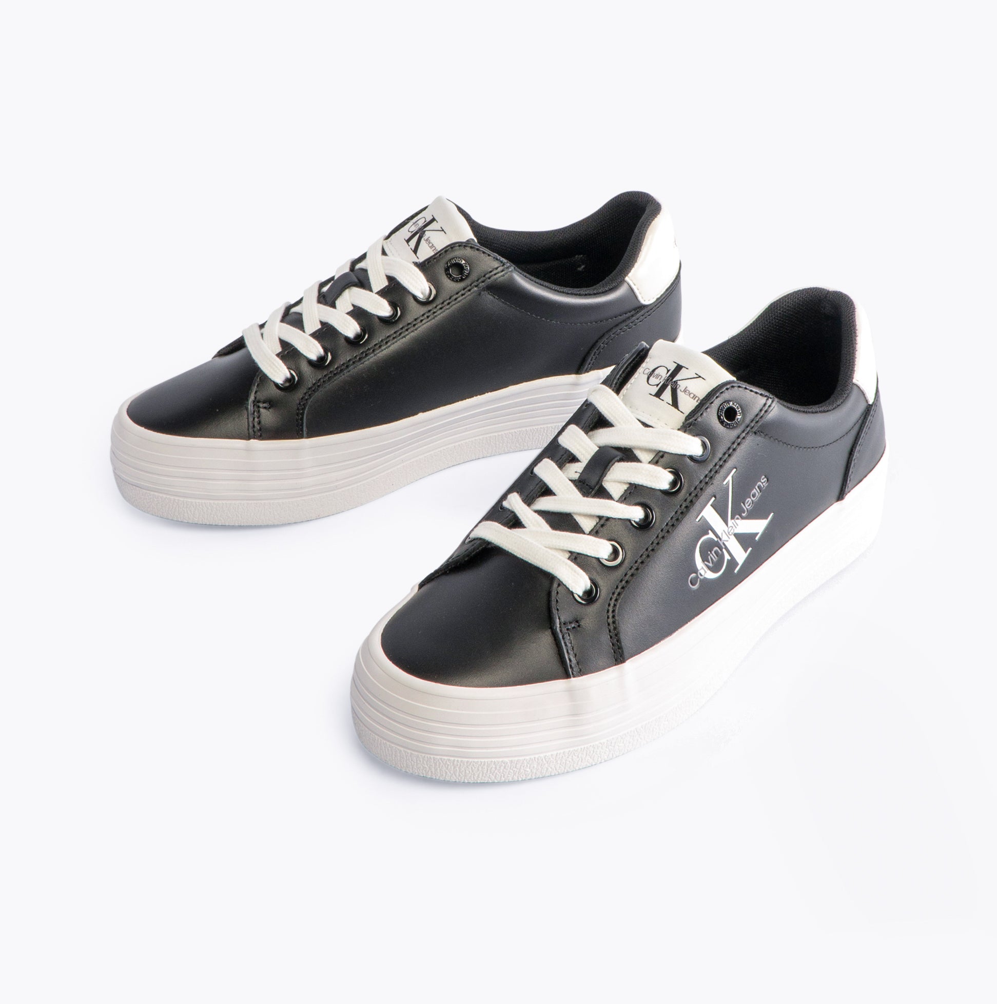 Calvin Klein FLATFORM LACEUP Womens Trainers Black/Bright White side view showing black leather upper and white sole.