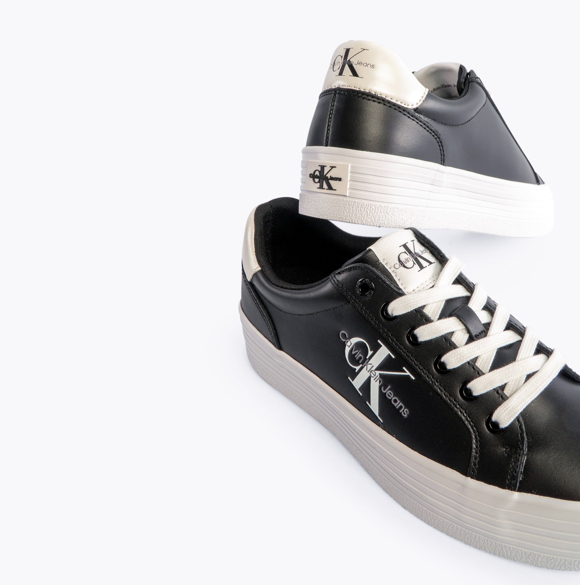 Calvin Klein FLATFORM LACEUP Womens Trainers Black/Bright White side view showcasing lace-up design and platform sole.