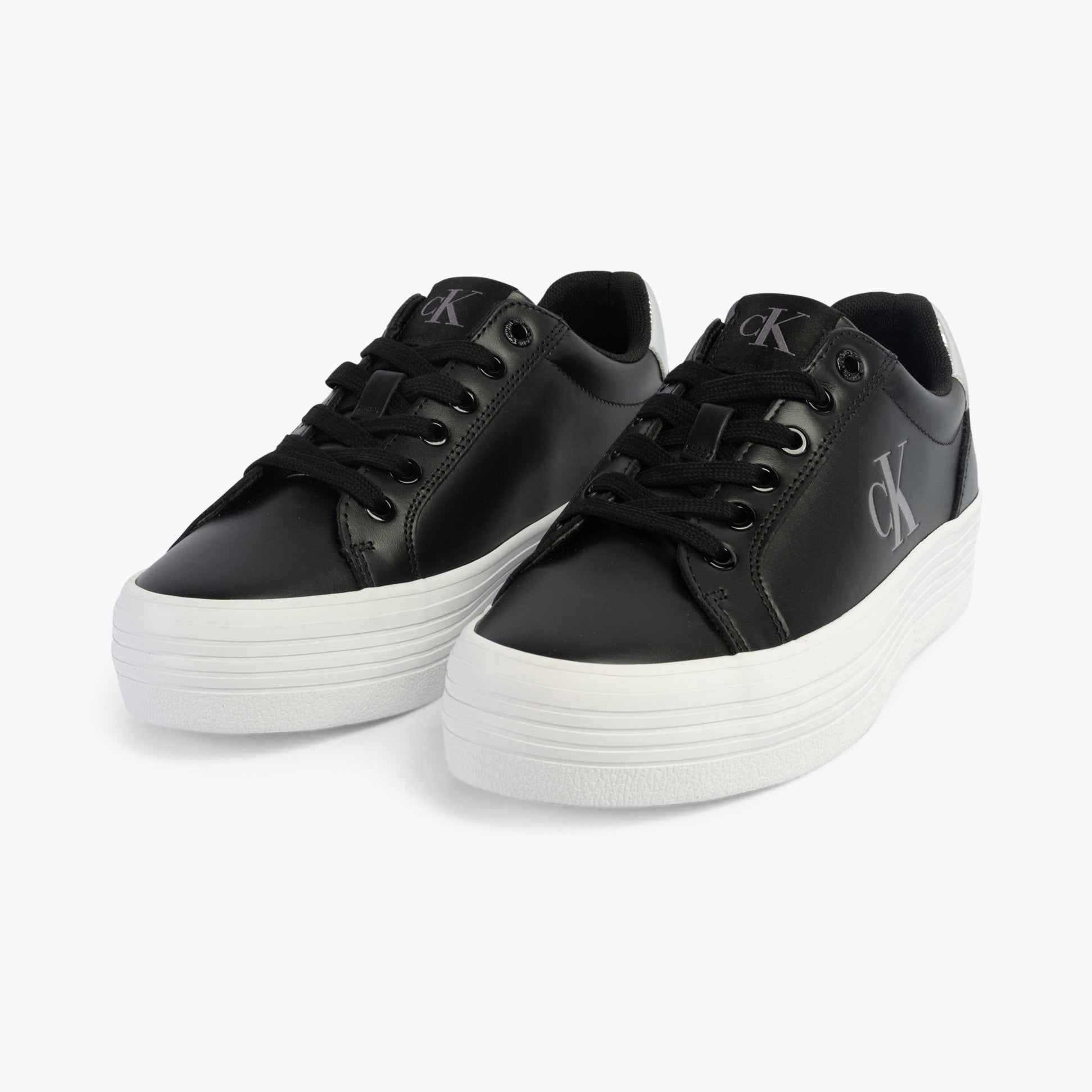 Calvin Klein BOLD VULCANISED FLATFORM Womens Trainers Black/Silver side view of black trainers with round toe and white platform sole