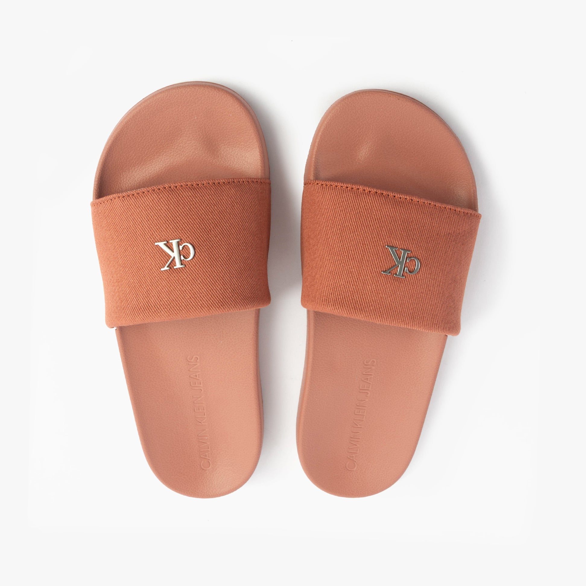 Calvin Klein LOGO MONOGRAM Womens Slides Aragon top view showcasing brown cotton upper and slip-on design.