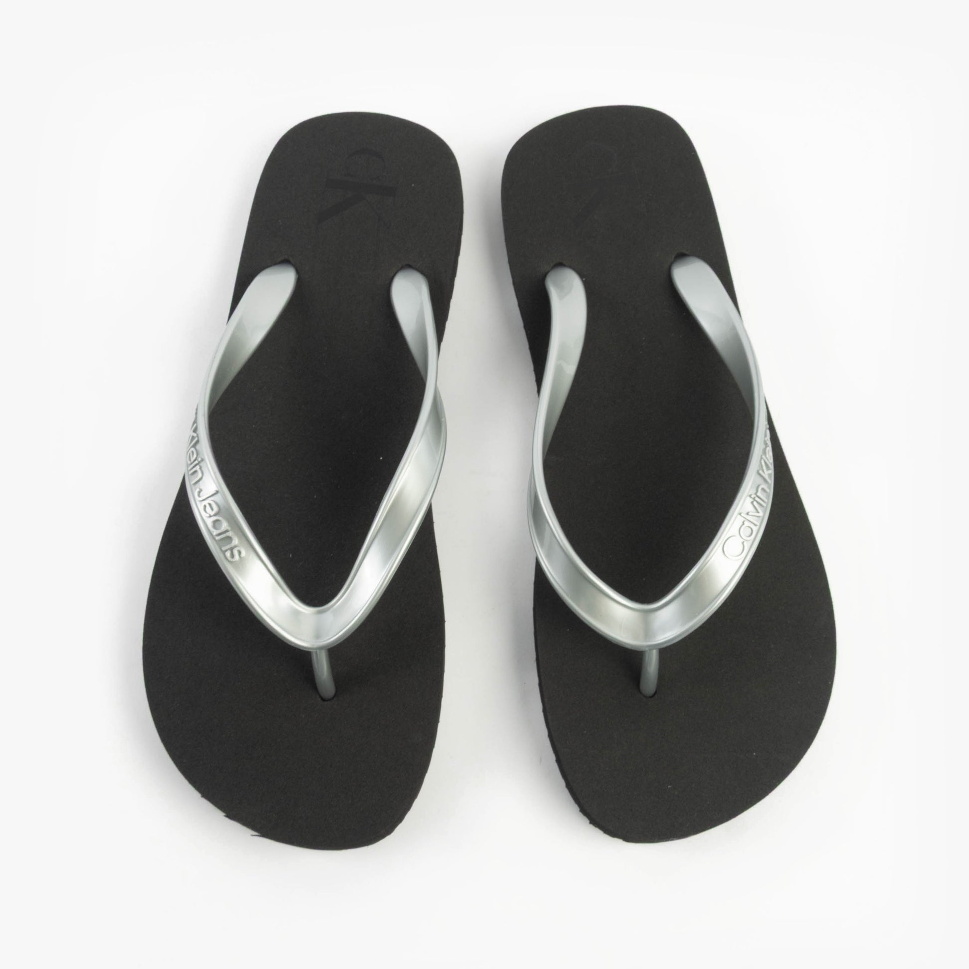 Calvin Klein BEACH SANDAL MONOLOG Womens Sandals Black/Silver top view showcasing the flat design and silver accents.