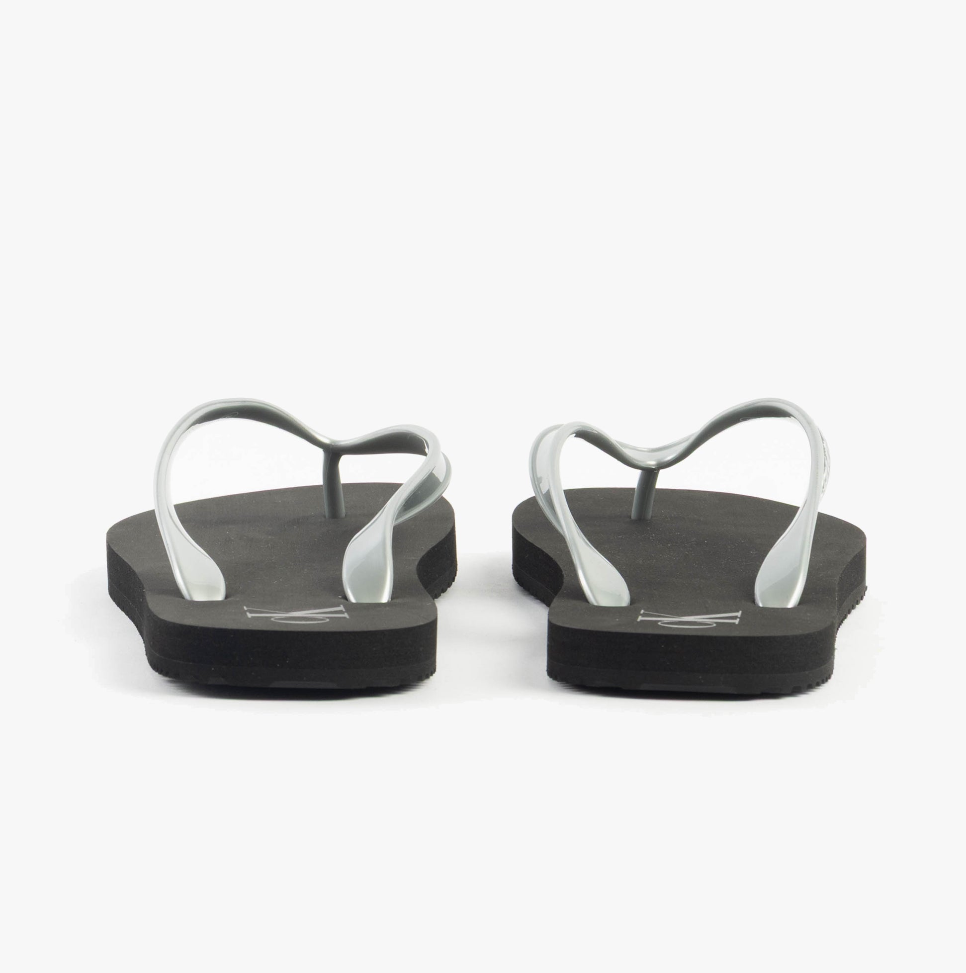 Calvin Klein BEACH SANDAL MONOLOG Womens Sandals Black/Silver rear view showcasing the flat sole and straps.