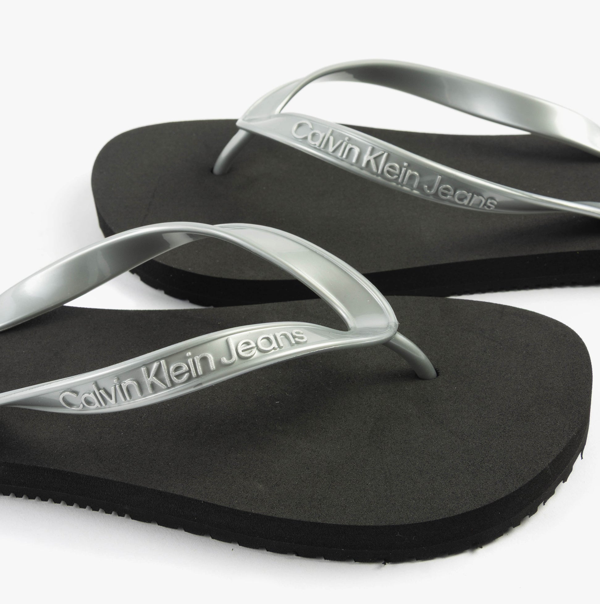 Calvin Klein BEACH SANDAL MONOLOG Womens Sandals Black/Silver top view showcasing the TPR upper and slip-on design.