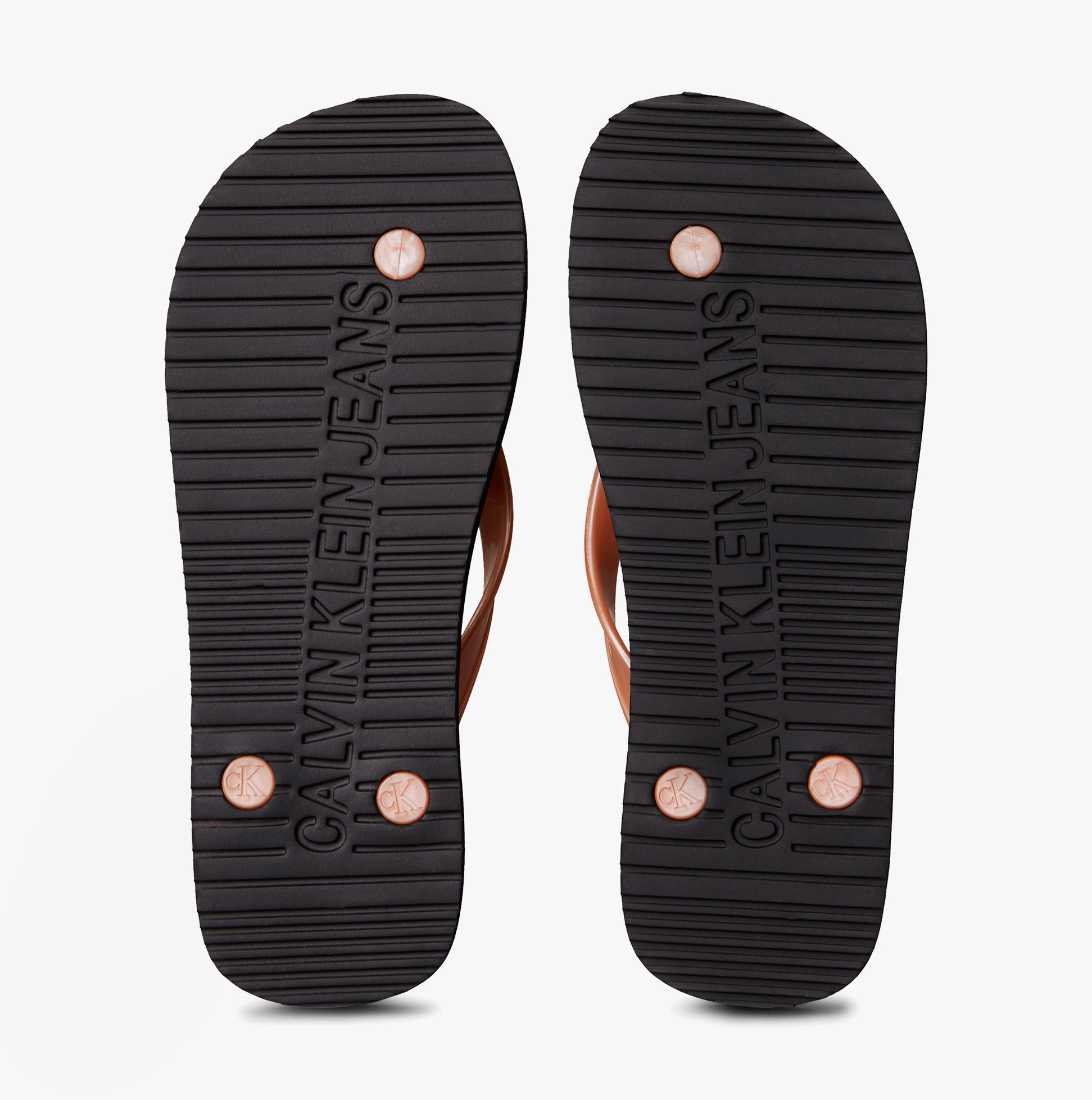 Calvin Klein BEACH SANDAL MONOLOGUE Womens Flip Flops Black/Dusty Coral bottom view showcasing tread and brand logo.