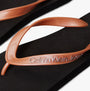 Calvin Klein BEACH SANDAL MONOLOGUE Womens Flip Flops Black/Dusty Coral close-up of straps detail view