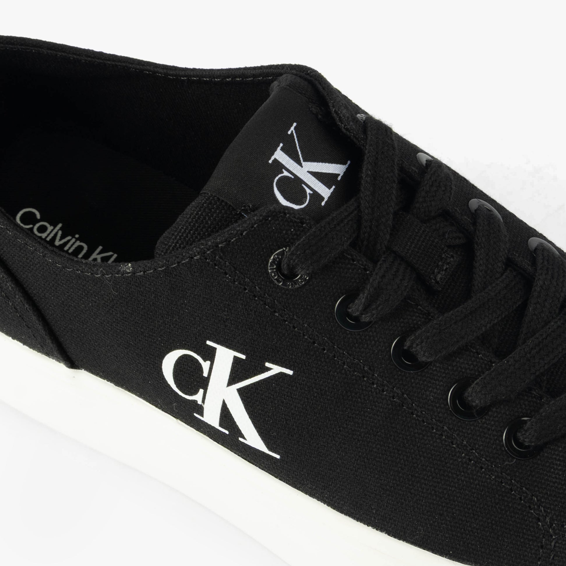 Calvin Klein VULC FLATFORM LOW Womens Trainers Black/Bright White detail view showing lace-up design and logo.