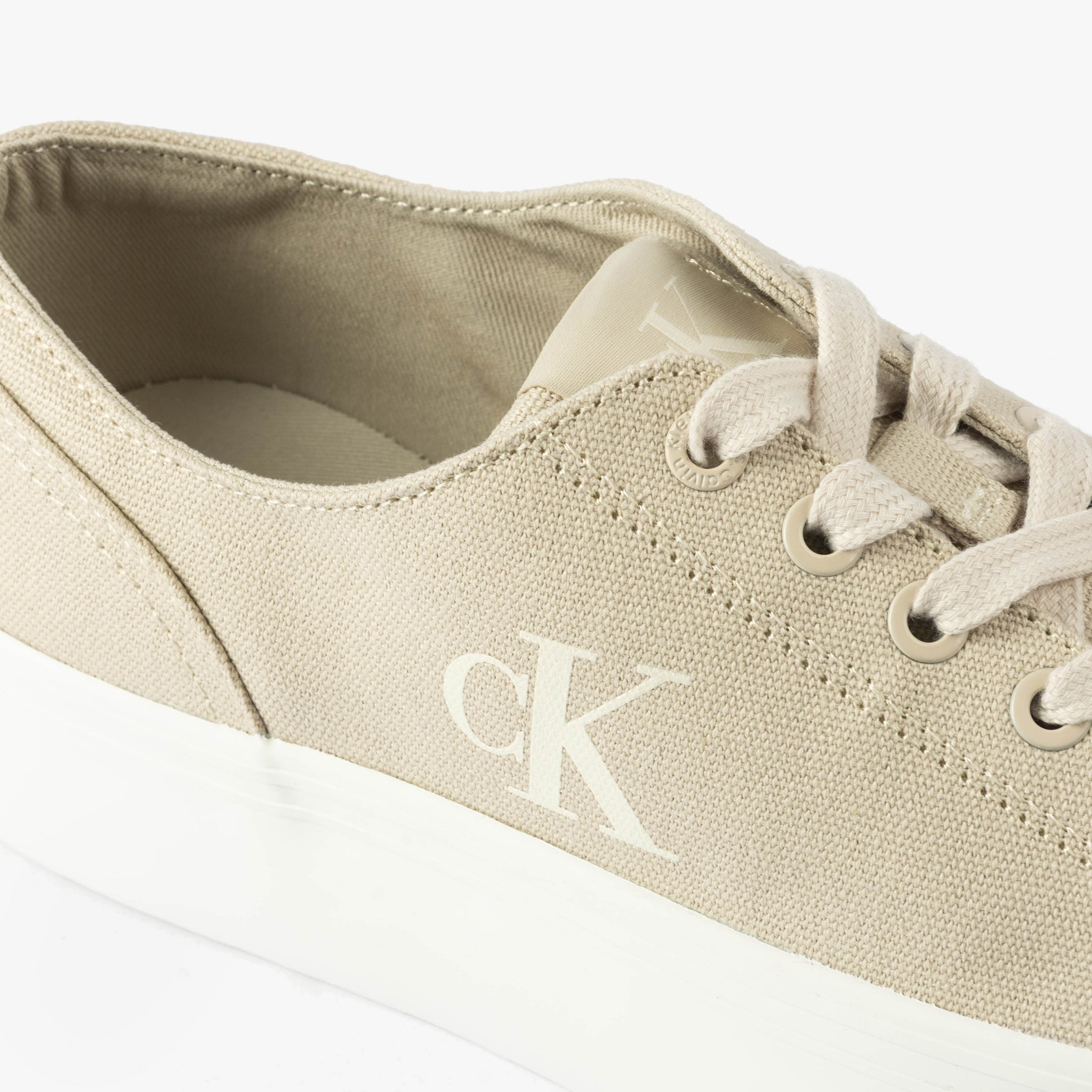Calvin Klein VULC FLATFORM LOW Womens Trainers Eggshell/Creamy White detail view showing canvas upper and lace-up closure.