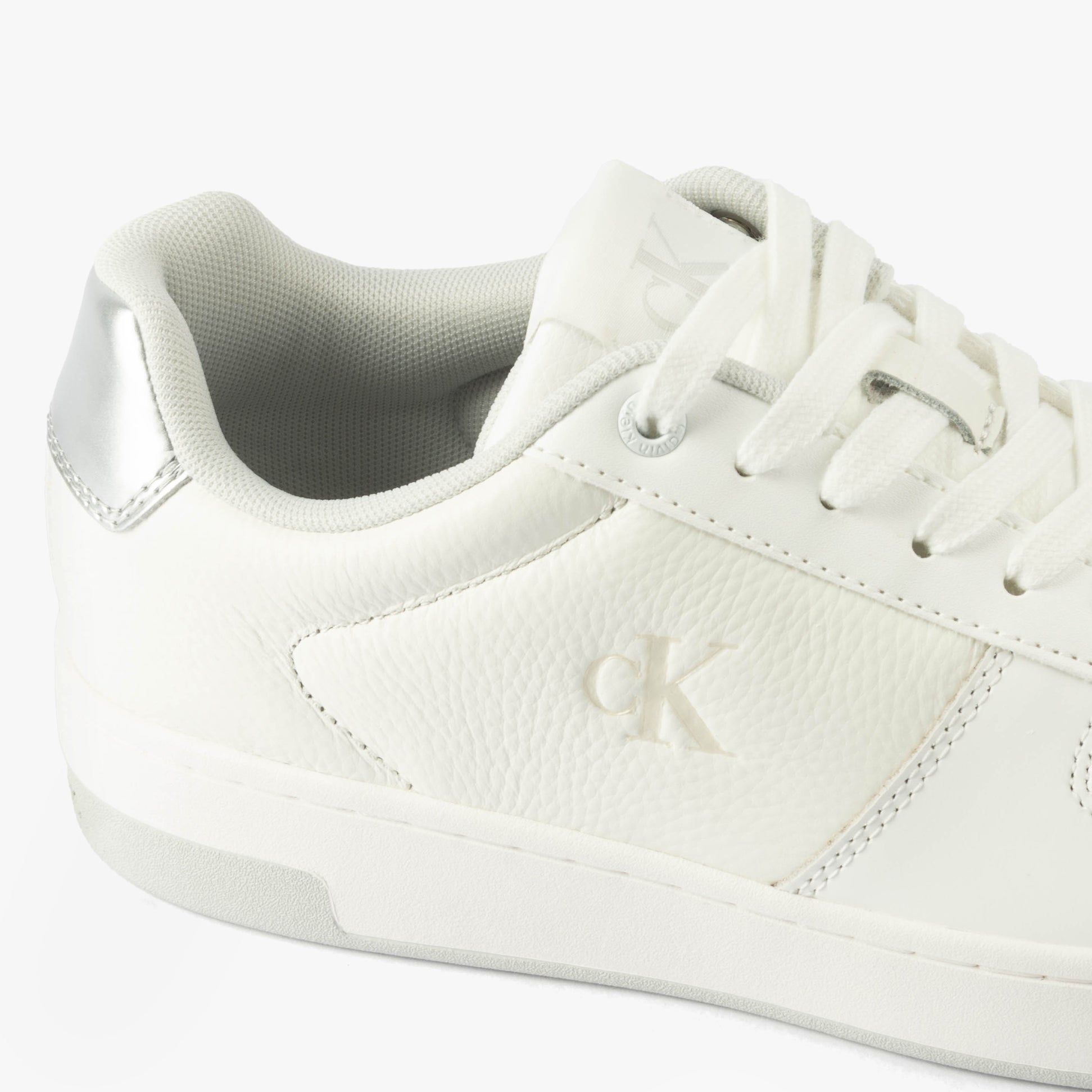 Calvin Klein BASKET CUPSOLE LOW Womens Trainers Bright White/Silver side view showing leather upper and silver detailing.