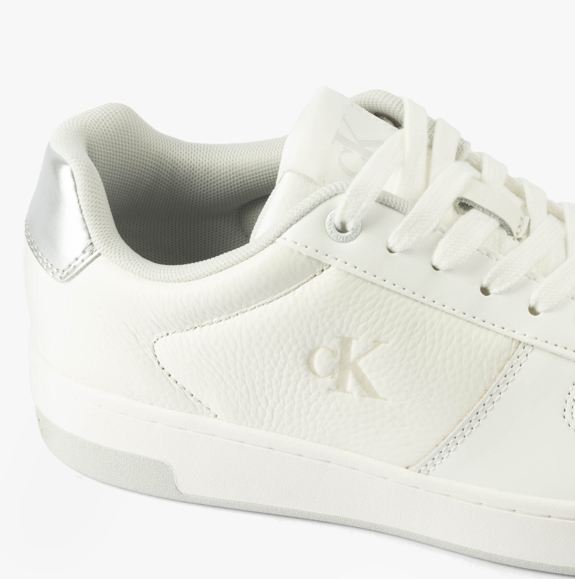Calvin Klein BASKET CUPSOLE LOW Womens Trainers Bright White/Silver side view showing leather upper and silver detailing.