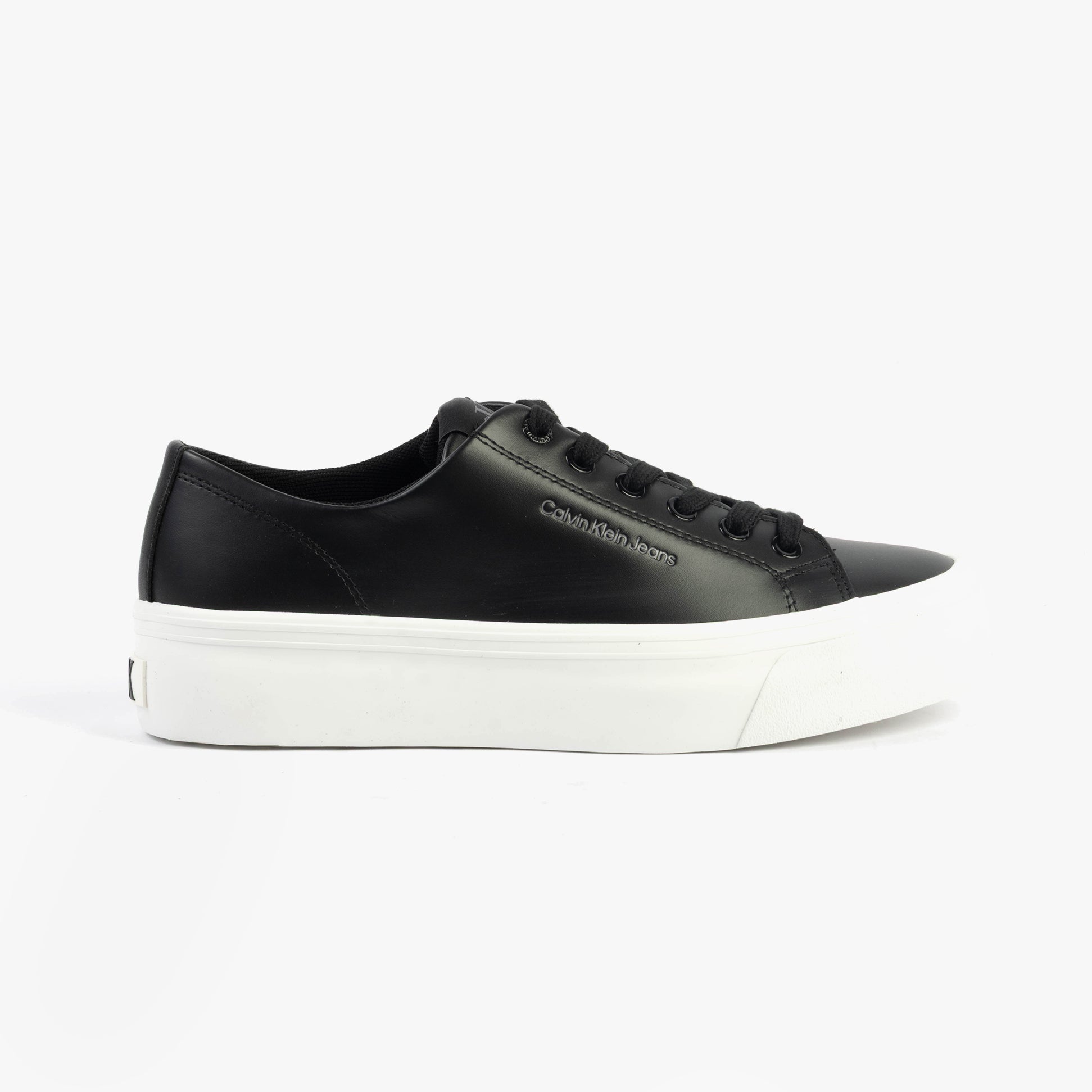 Calvin Klein VULC FLATFORM LOW Womens Trainers Black/Bright White side view showcasing leather upper and rubber sole.
