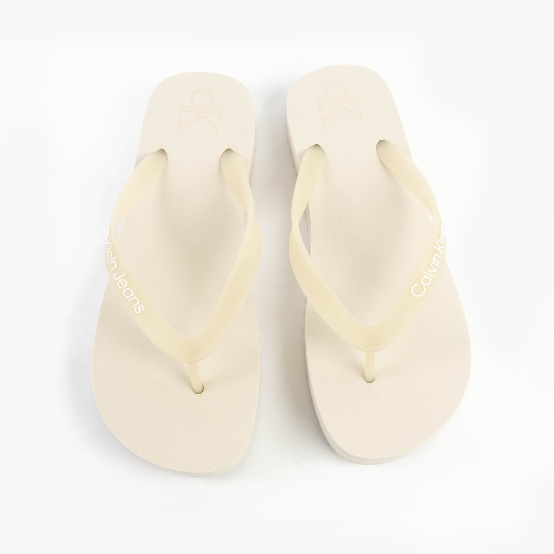 Calvin Klein BEACH SANDAL FLATFORM Womens Sandals Eggshell/Bright White top view showcasing the slip-on design.