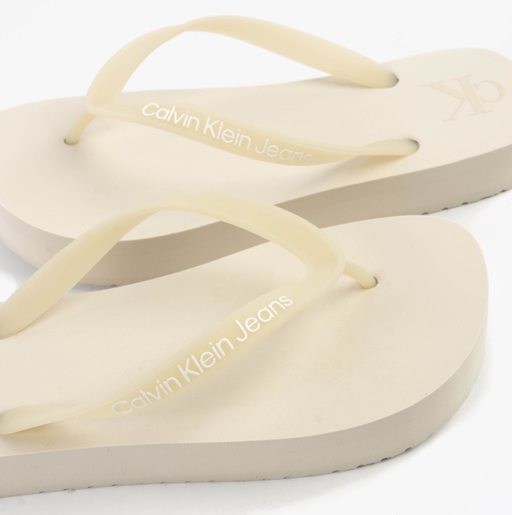 Calvin Klein BEACH SANDAL FLATFORM Womens Sandals Eggshell/Bright White close-up view of straps and footbed.