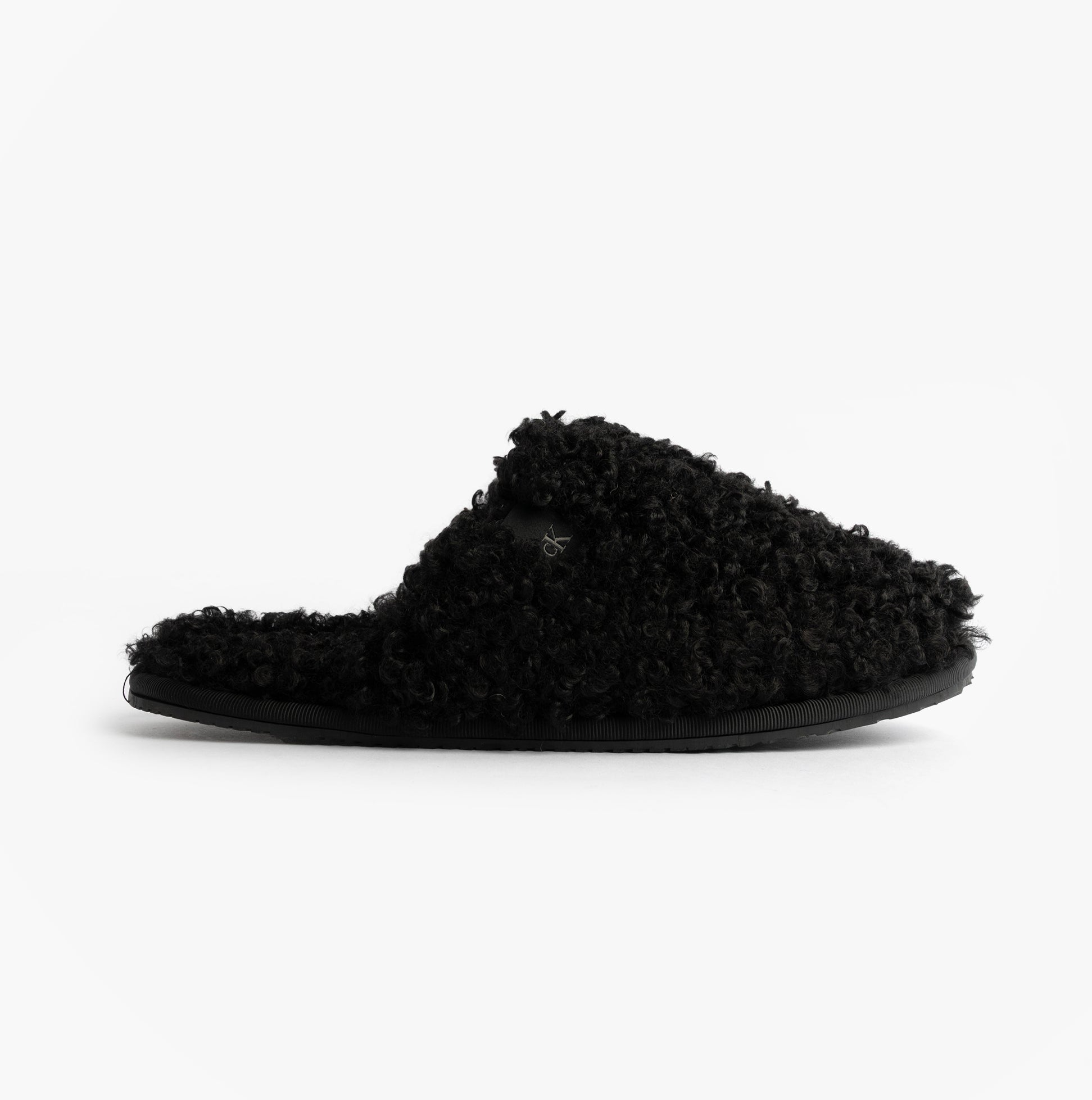 Calvin Klein CLOSE SLIPPER FUR Womens Slippers Black side view showing faux fur texture and slip-on design.