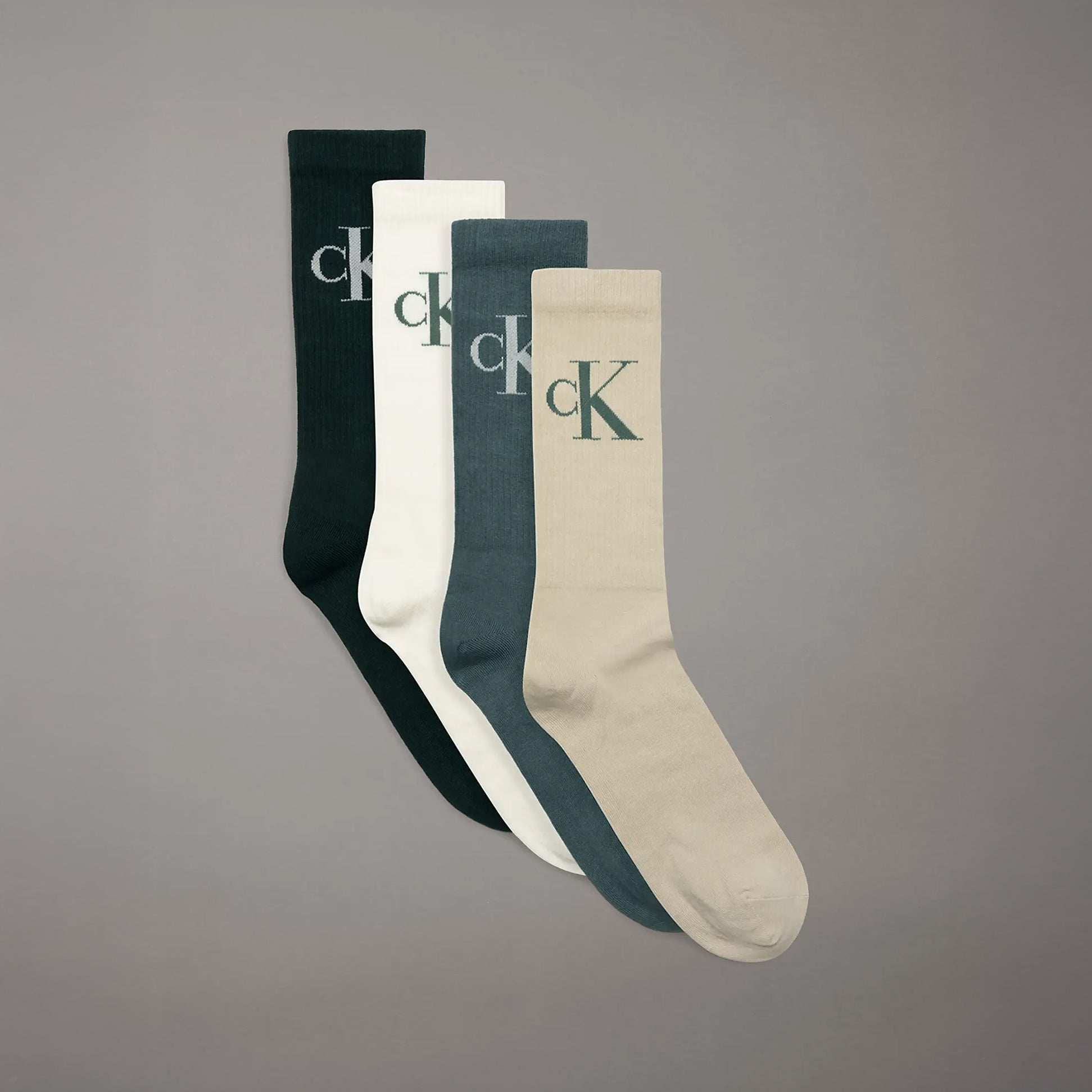 Calvin Klein 4 Pack Giftboxed Trainer Mens Crew Socks Green Combo in a front view, showcasing green and neutral colors with logo.