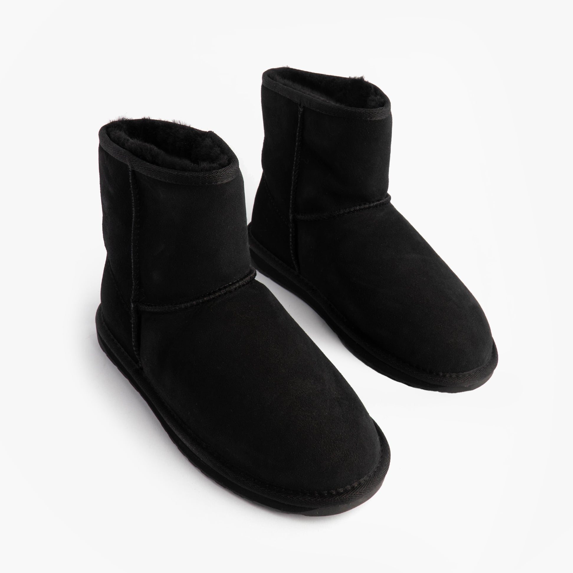 EMU Australia STINGER MINI Womens Sheepskin Boot Black side view, showing soft sheepskin upper and comfortable design.