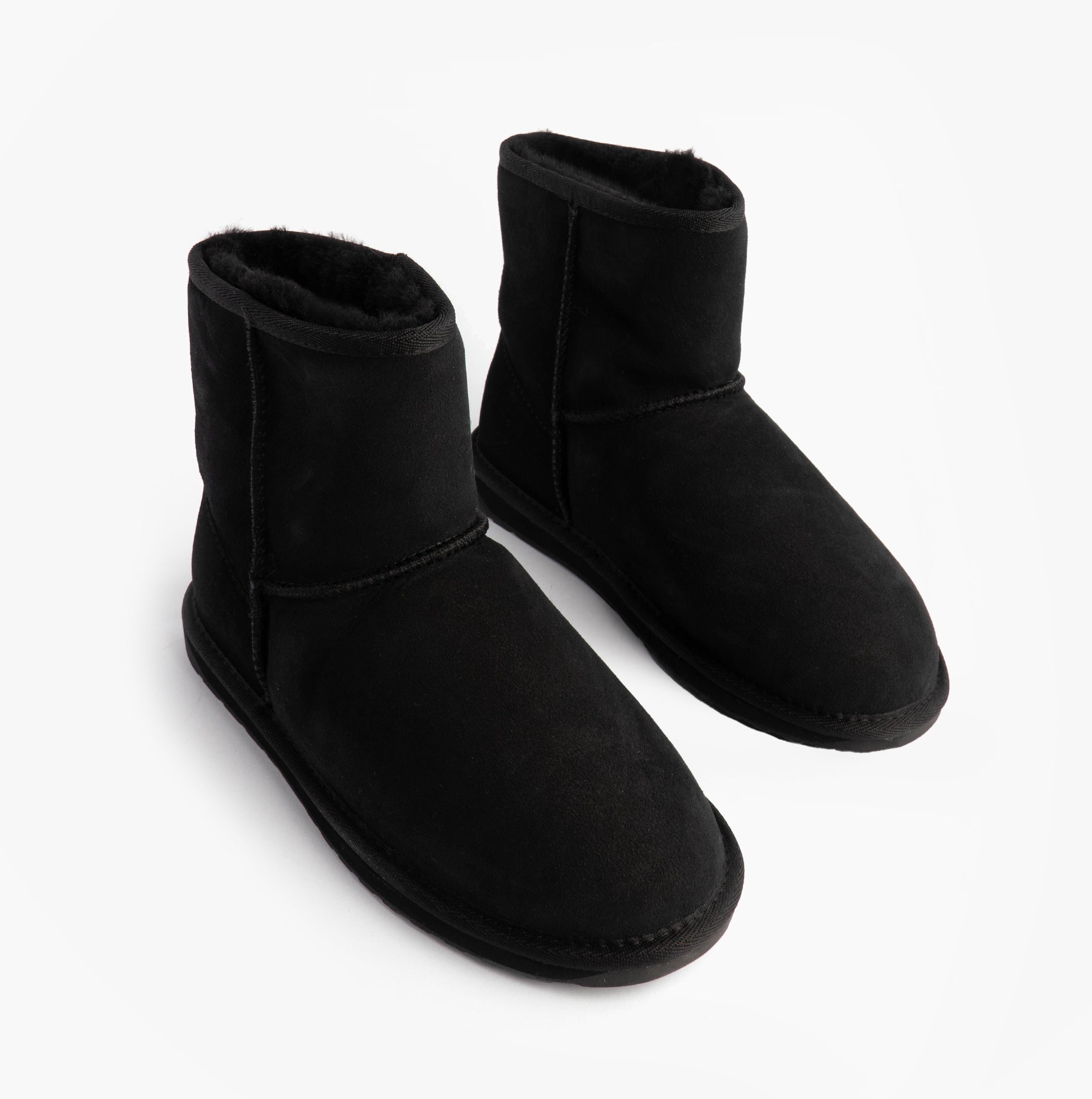 EMU Australia STINGER MINI Womens Sheepskin Boot Black side view, showing soft sheepskin upper and comfortable design.