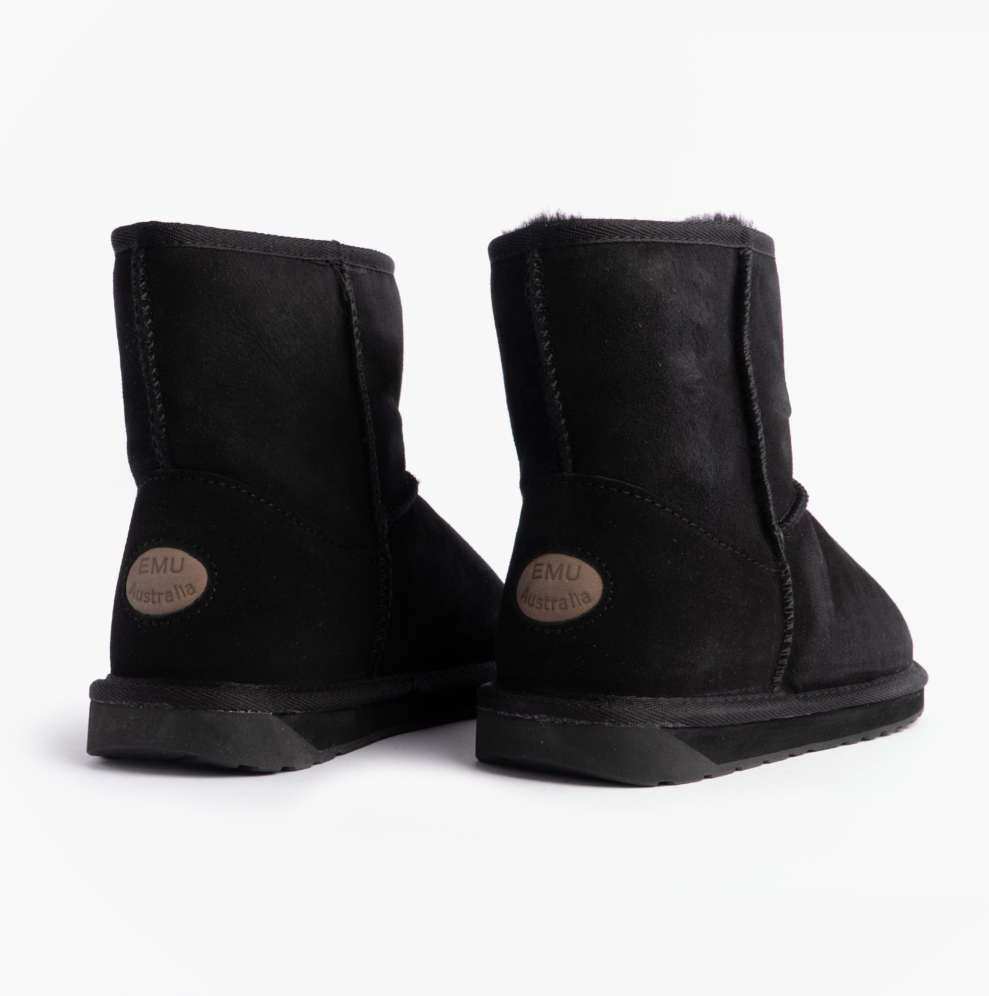EMU Australia STINGER MINI Womens Sheepskin Boot Black rear view showcasing soft sheepskin upper and rubber sole.