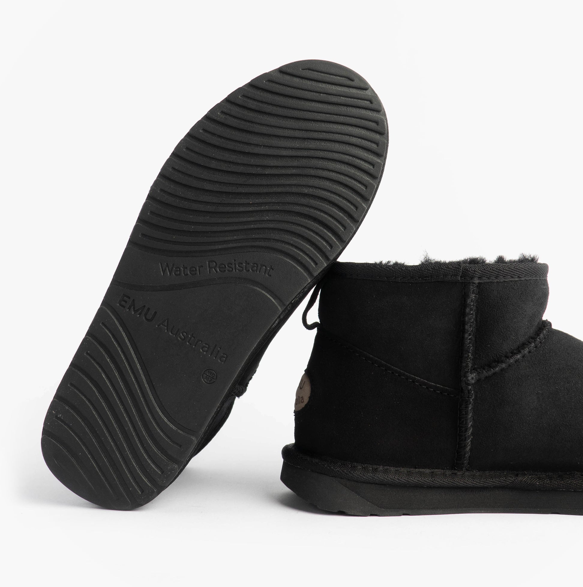 EMU Australia STINGER MICRO Womens Sheepskin Boot Black sole view showcasing rubber material and water-resistant feature.