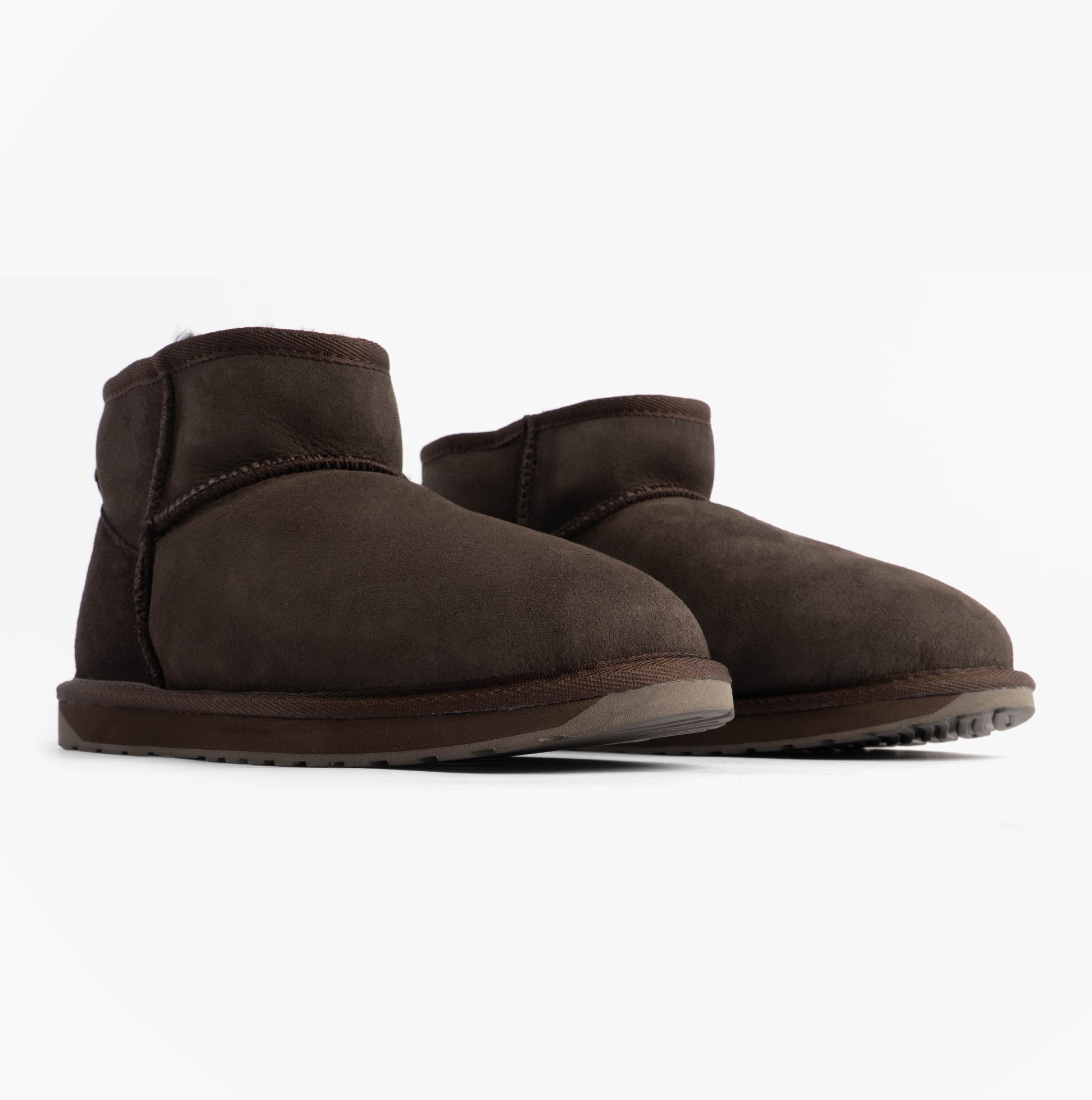 EMU Australia STINGER MICRO Womens Sheepskin Boot Chocolate side view showing shearling design and rubber sole.