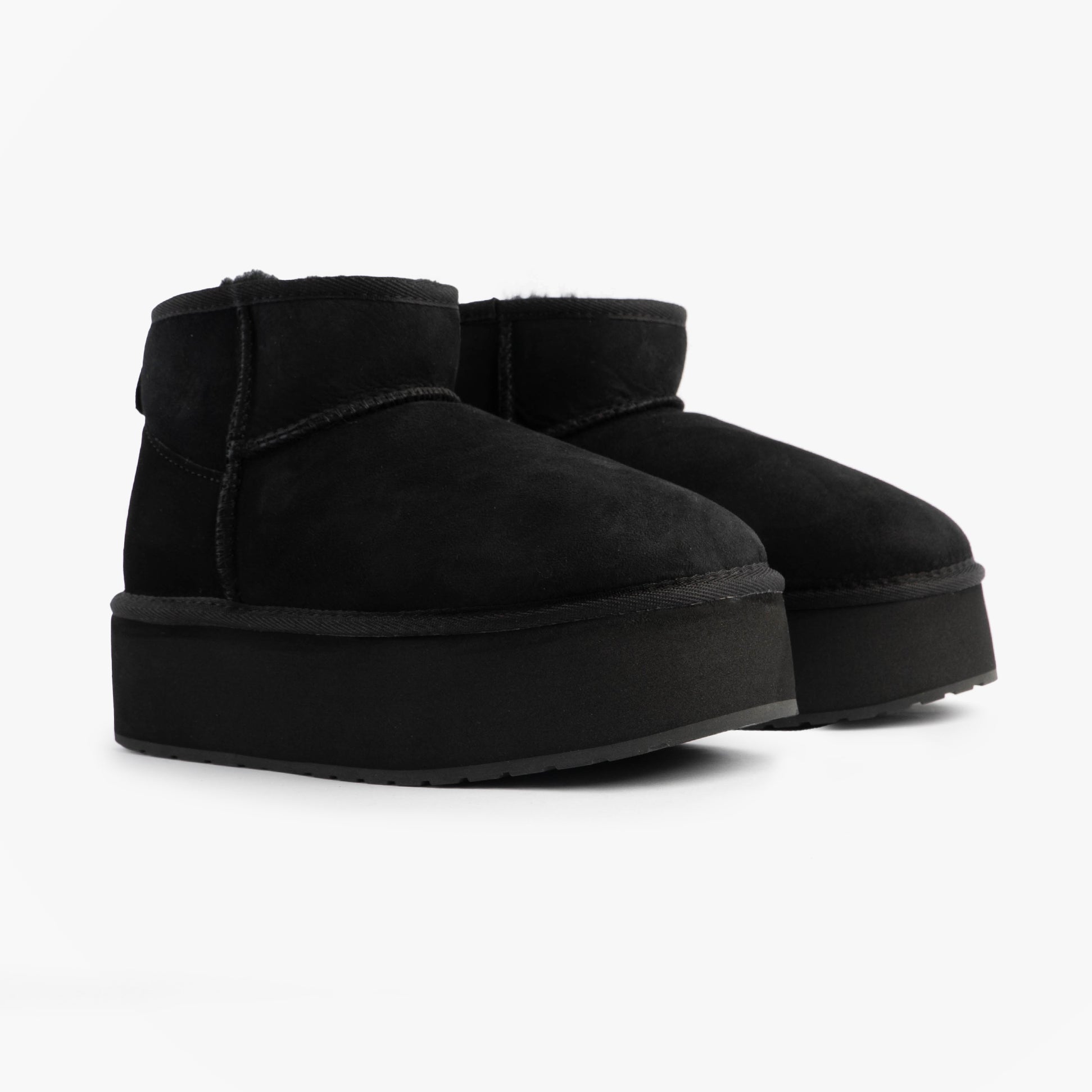 EMU Australia STINGER MICRO FLATFORM Womens Sheepskin Boot Black side view highlighting the sheepskin material and platform sole.