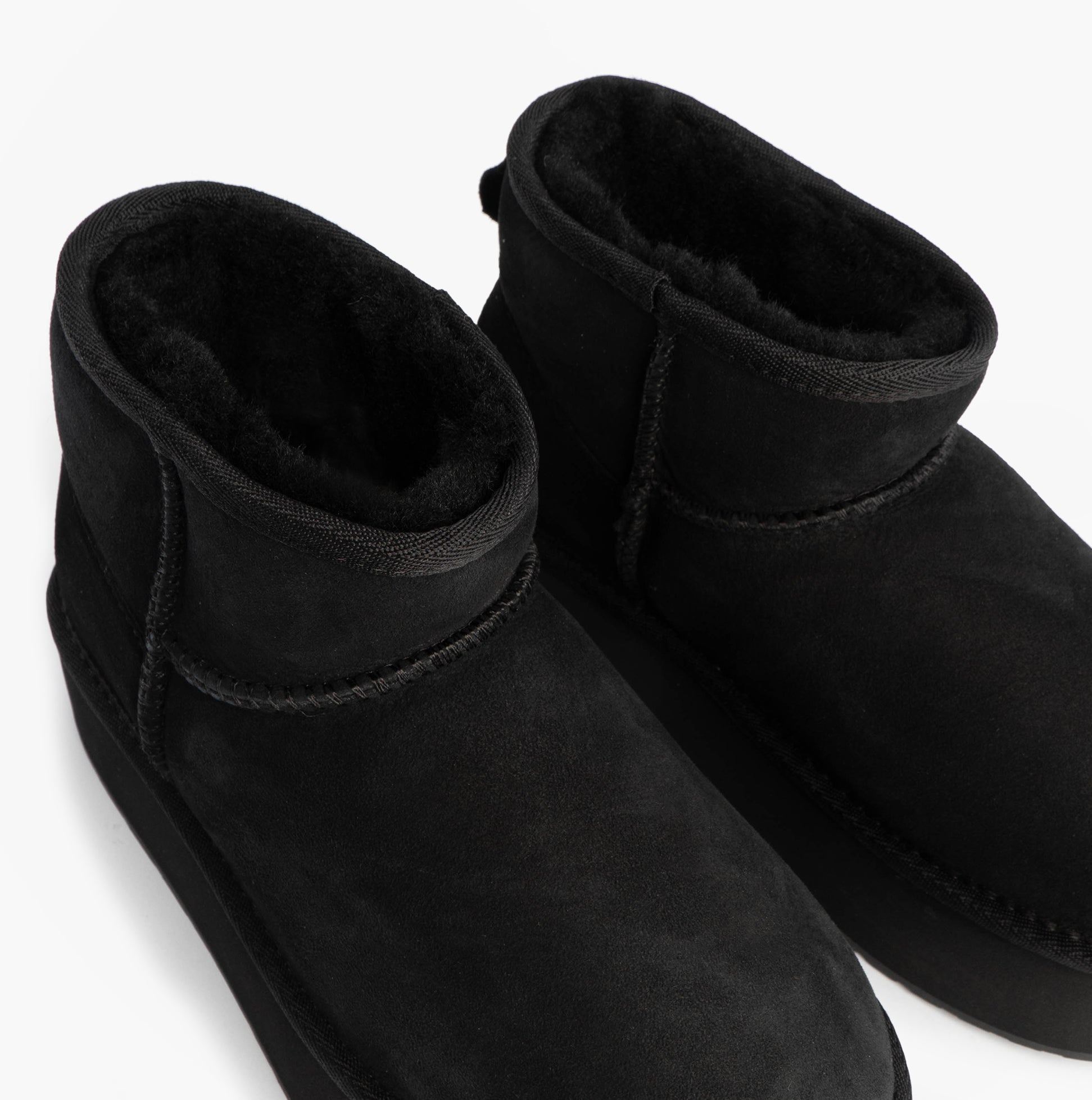 EMU Australia STINGER MICRO FLATFORM Womens Sheepskin Boot Black top view showing soft sheepskin lining and mid-calf design.