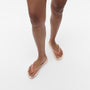 FitFlop IQUSHION Womens Flip Flops Beige front view on model's feet with a lightweight and comfortable design.
