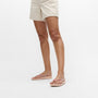FitFlop IQUSHION Womens Flip Flops Beige side view on a woman, showcasing comfort and lightweight design.