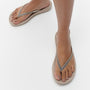 FitFlop IQUSHION OMBRE SPARKLE Womens Flip Flops On Taupe/Pewter side view on model's feet with sparkling straps.