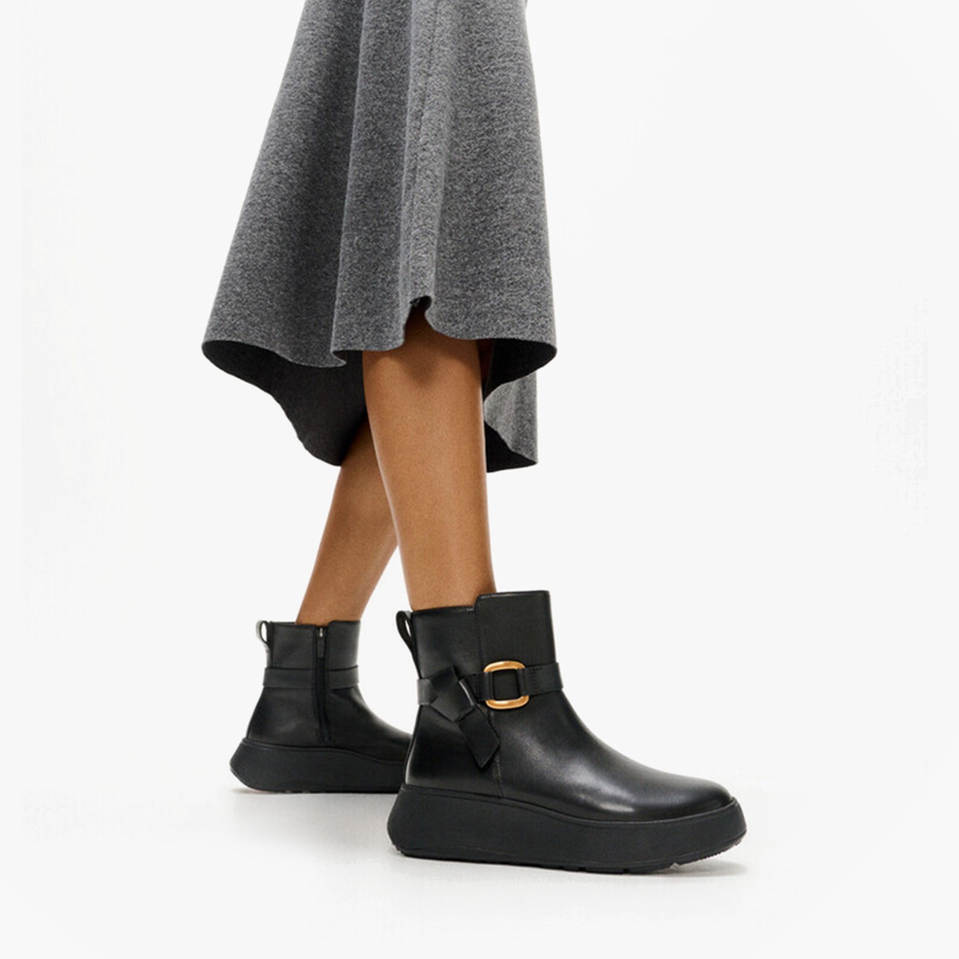 FitFlop F-MODE SQUARE-RING LEATHER FLATFORM Ladies Ankle Boots Black side view on model wearing a grey skirt