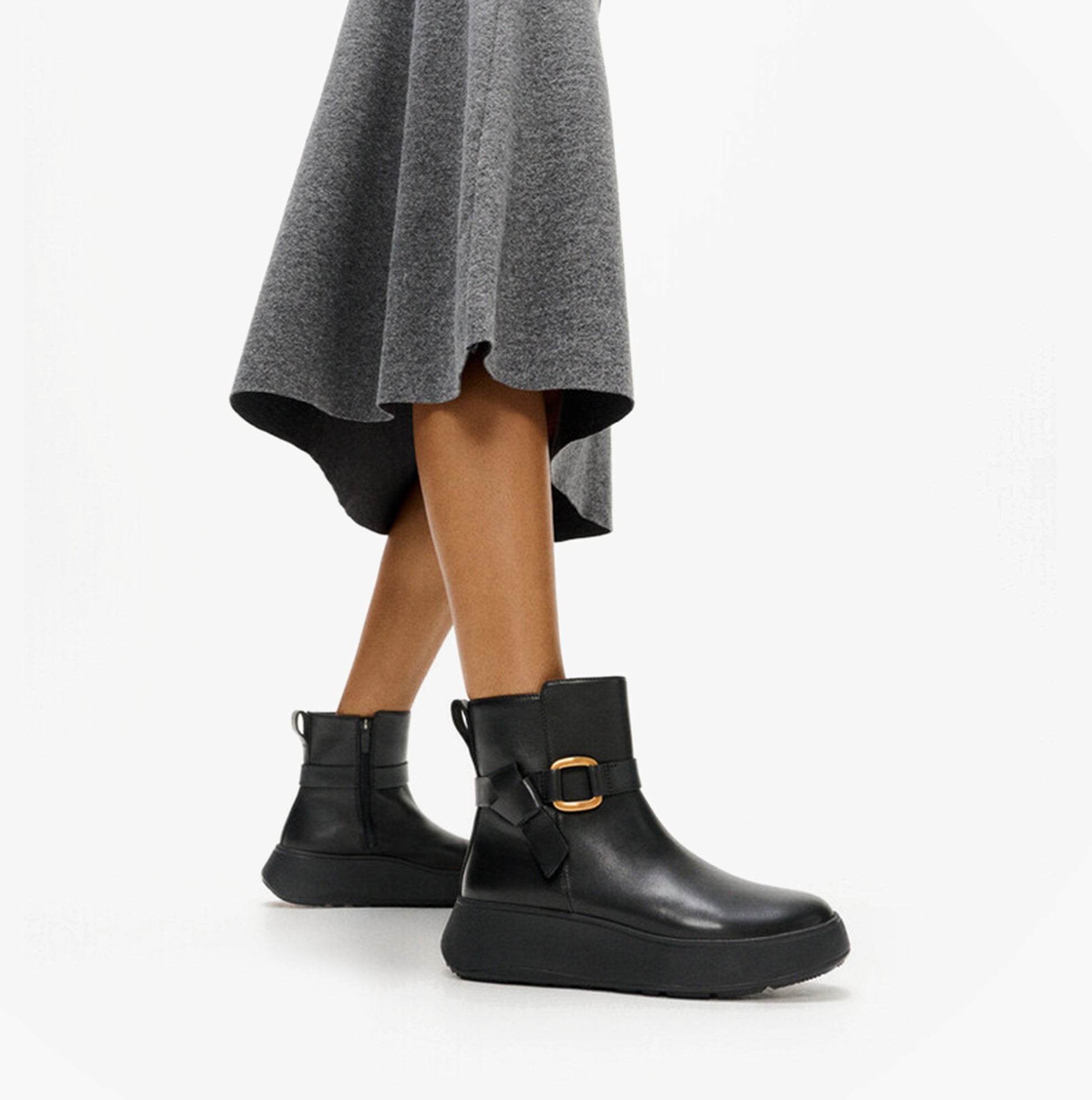 FitFlop F-MODE SQUARE-RING LEATHER FLATFORM Ladies Ankle Boots Black side view on model wearing a grey skirt