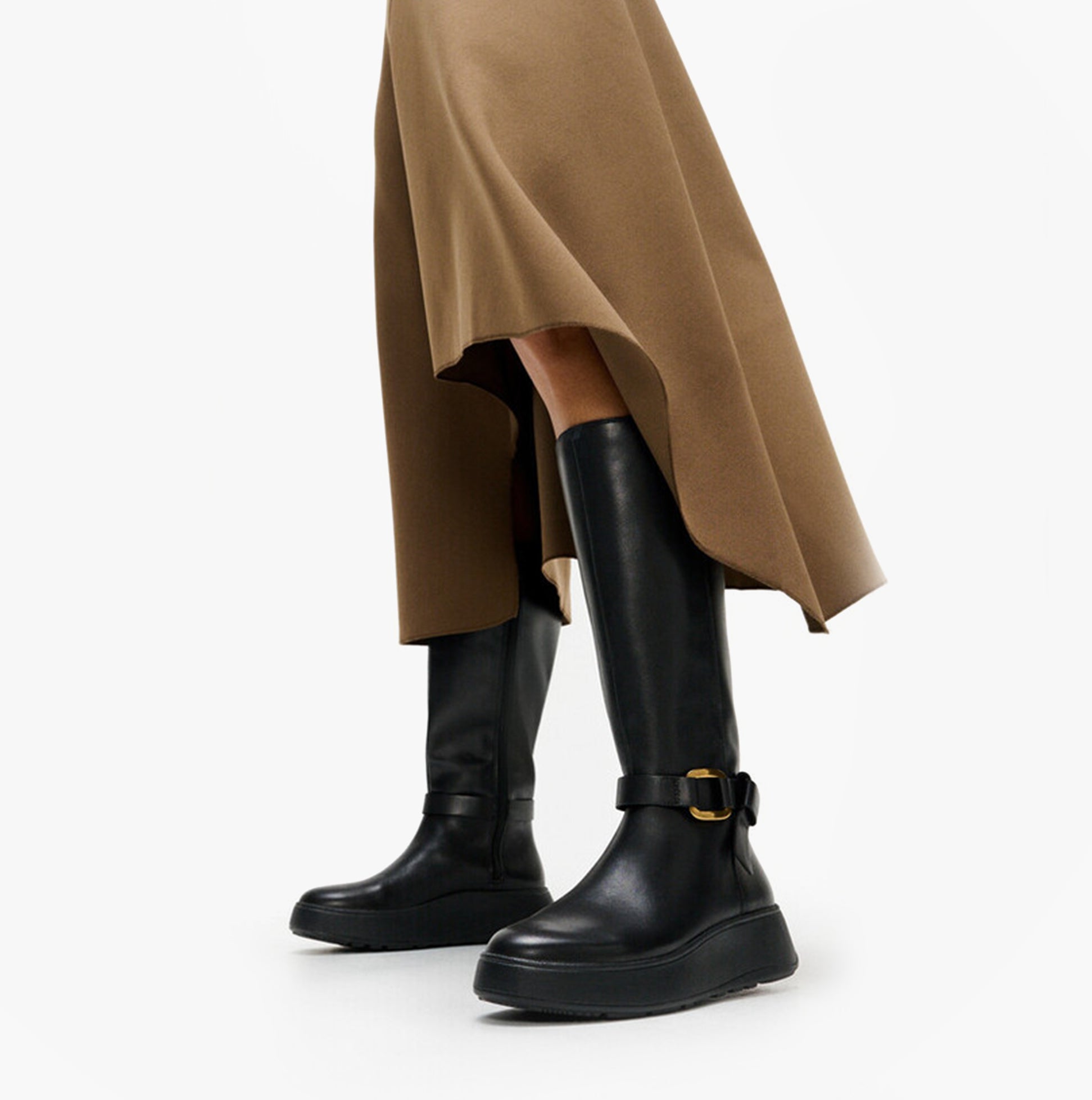 FitFlop F-MODE SQUARE-RING LEATHER FLATFORM Ladies Tall Boots Blac side view with stylish skirt