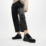 FitFlop F-MODE Womens Leather Trainers Urban Black detail view with model wearing black jeans and trainers.