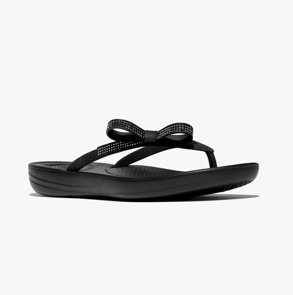 FitFlop iQUSHION GLITZ-BOW Ladies Flip Flops Black side view showcasing the stylish bow and comfortable design.