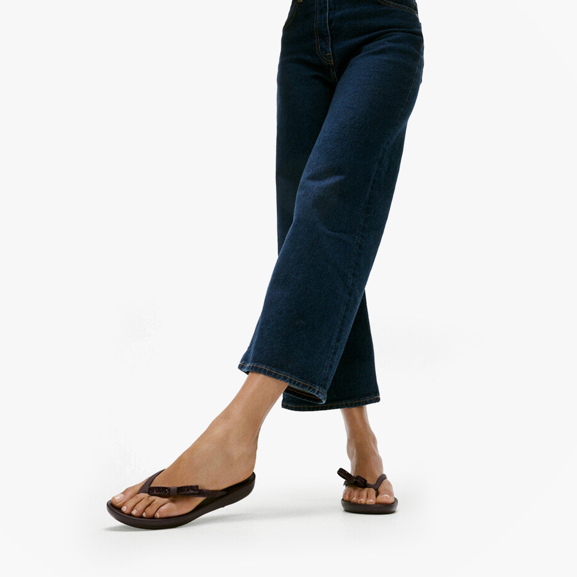 FitFlop iQUSHION GLITZ-BOW Ladies Flip Flops Plumberry side view worn with jeans.