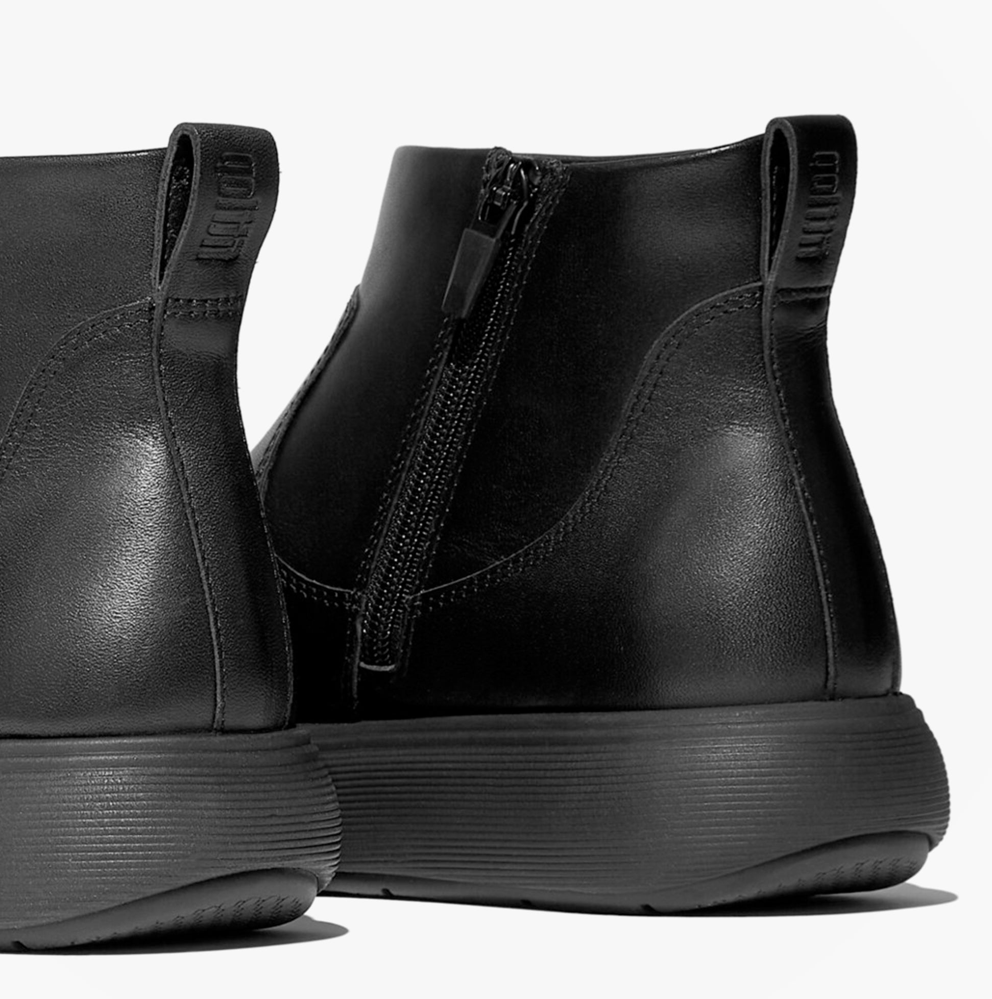 FitFlop iQ-COMFF LEATHER ZIP Womens Chelsea Boots All Black back view showing zipper and sleek silhouette.