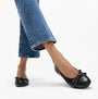 FitFlop DELICATO GLITZ-BOW LEATHER Womens Ballet Black, side view with denim jeans, showcasing the bow detail.