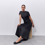 FitFlop DELICATO BOW SEQUIN BALLET Womens Ballet Black shown in side view with a model wearing a black dress and black ballet shoes.