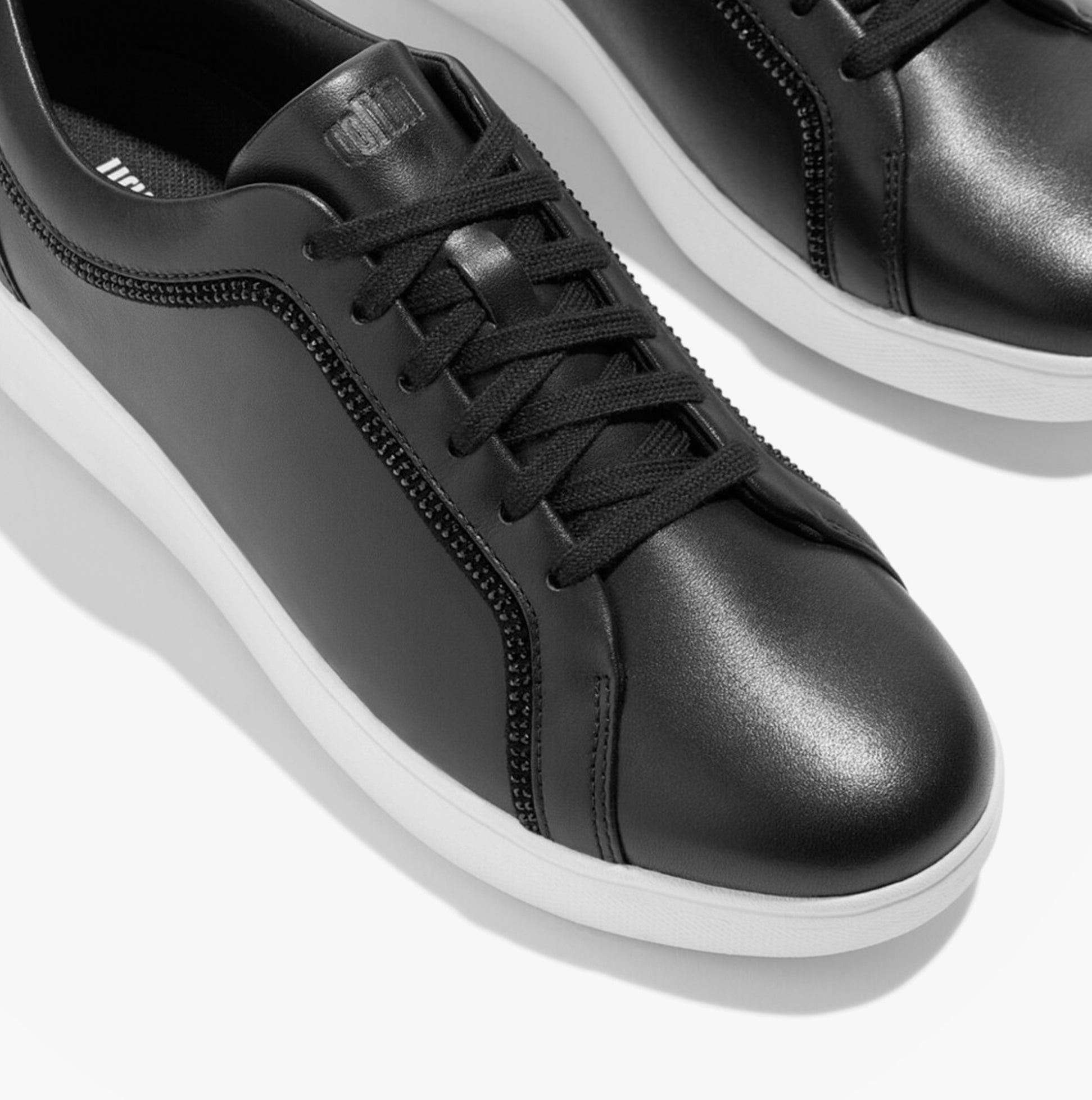 FitFlop RALLY CRYSTAL-TRIM LEATHER Womens Fashion Trainers Black top view highlighting lace-up design and details.