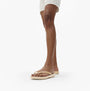 FitFlop IQUSHION Womens Flip Flops Gold side view on model's foot, showcasing the lightweight and comfortable design.