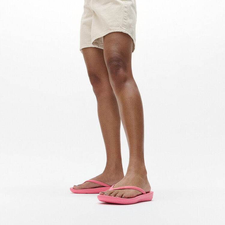 FitFlop IQUSHION ERGONOMIC Womens Flip Flops Geranium Pink side view worn with shorts