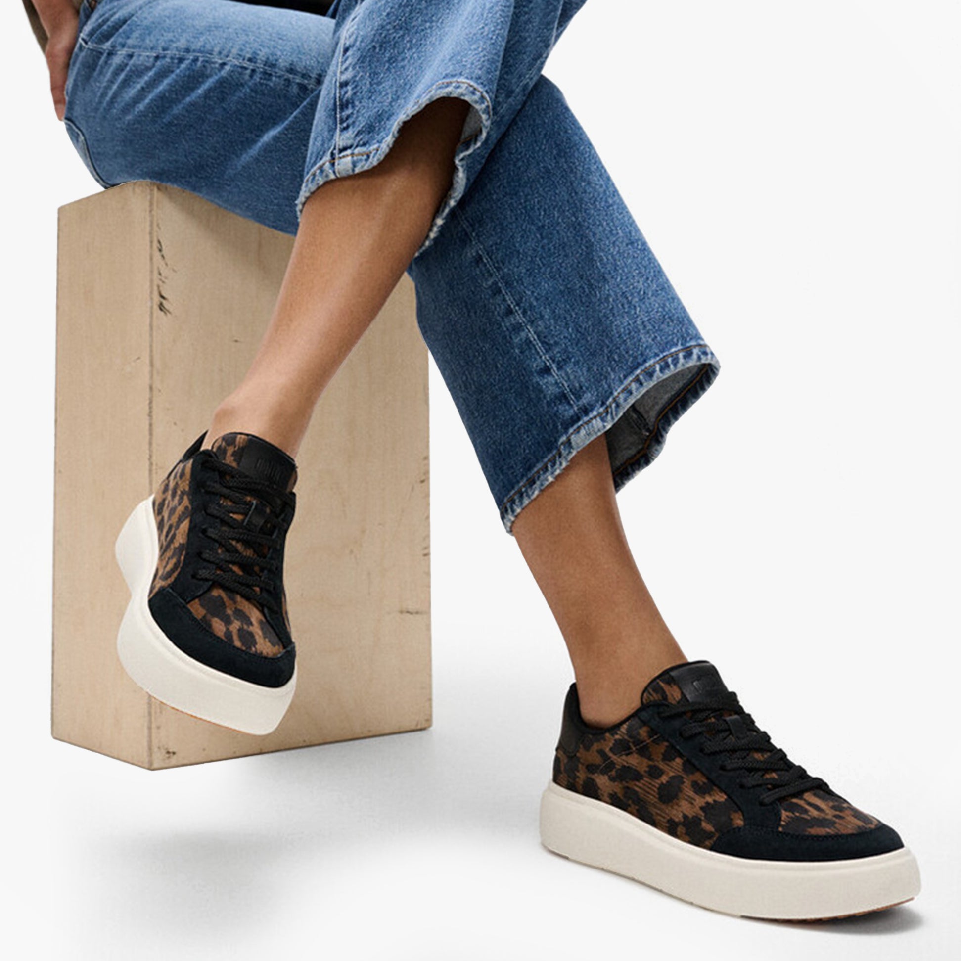 FitFlop 'Ready To Go' LEOPARD SUEDE Ladies Sneakers Black/Chocolate Mix side view on a model with casual jeans.