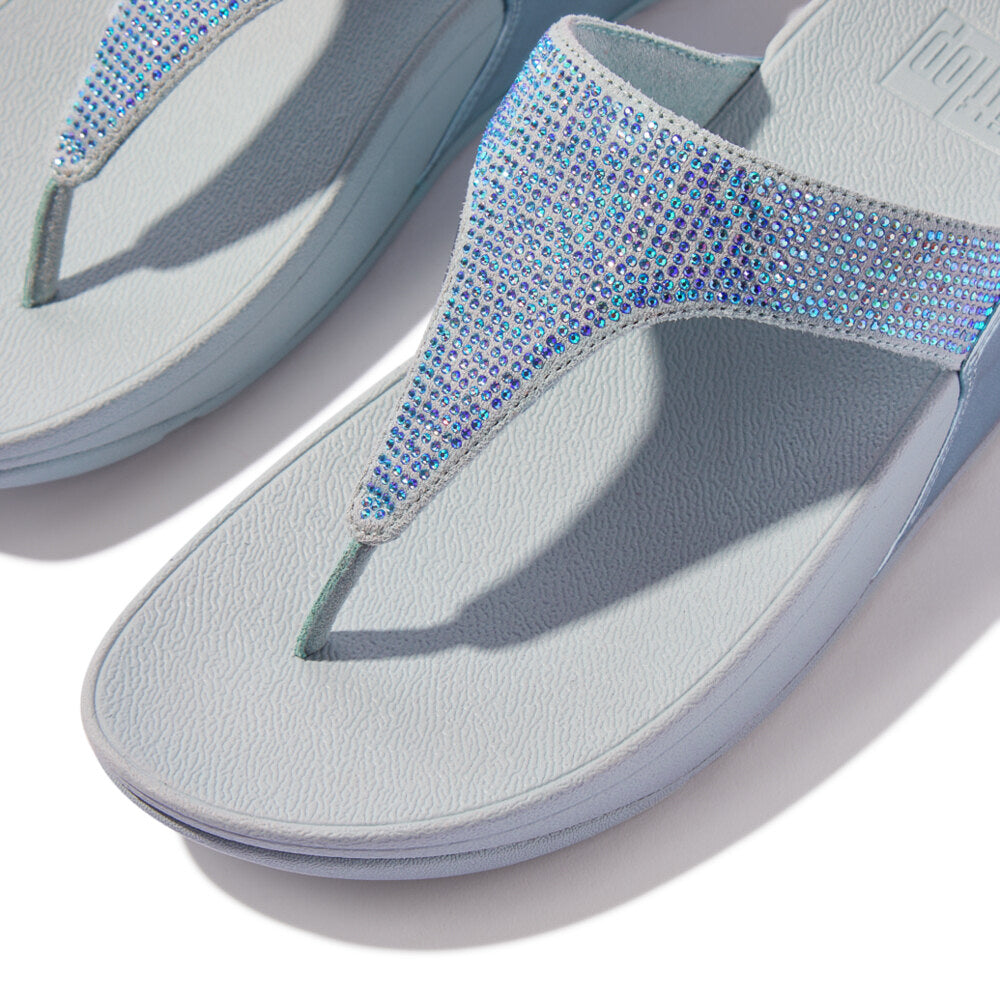FitFlop LULU CRYSTAL EMBELLISHED Womens Toe Post Sandals Quiet Blue, detail view showcasing crystal embellishments on a light blue background.