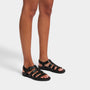 FitFlop GRACIE RUBBER-BUCKLE Womens Fisherman Sandals All Black side view on model's feet