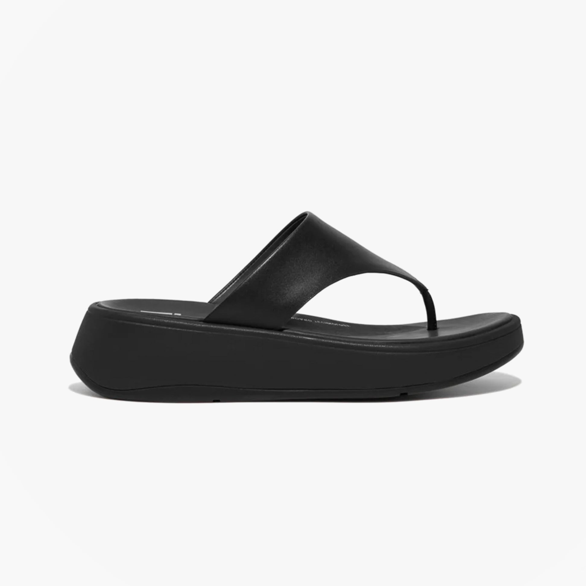 FitFlop F-MODE LEATHER FLATFORM Womens Toe Post Sandals All Black side view featuring leather upper and slip-on design.