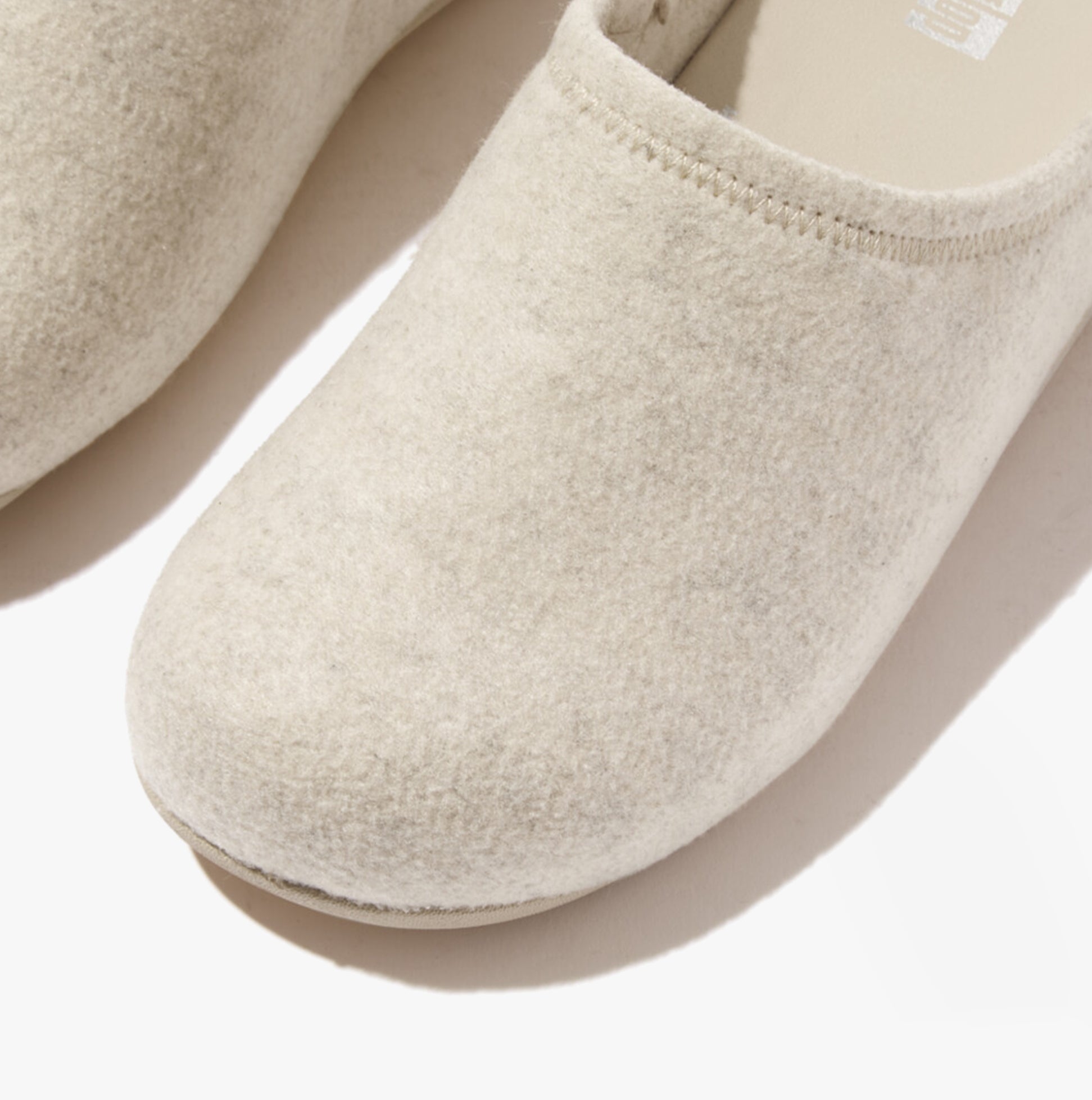 FitFlop SHUV e01 Womens Clog Slippers Ivory top view showing felt upper and round toe design.