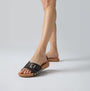 FitFlop iQUSHION ADJUSTABLE BUCKLE LEATHER Womens Slides Black side view on foot with a cork sole and adjustable buckle.