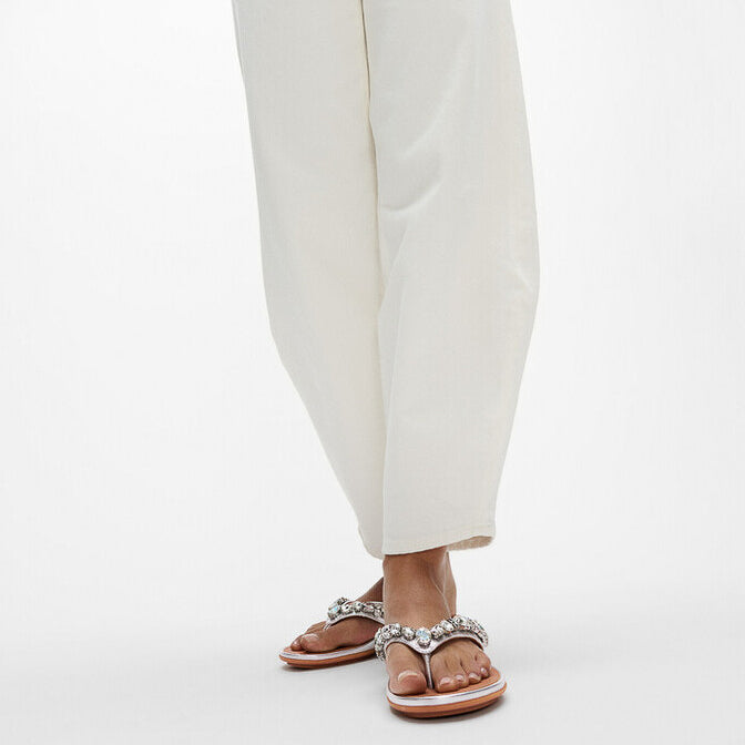 FitFlop GRACIE JEWEL-DELUXE Womens Flip Flops Silver worn by model in a casual outfit, showcasing side view with sparkling embellishments.