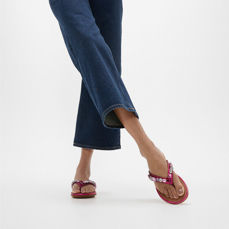 FitFlop GRACIE JEWEL-DELUXE Womens Flip Flops Metallic Wild Raspberry side view on model wearing denim pants.
