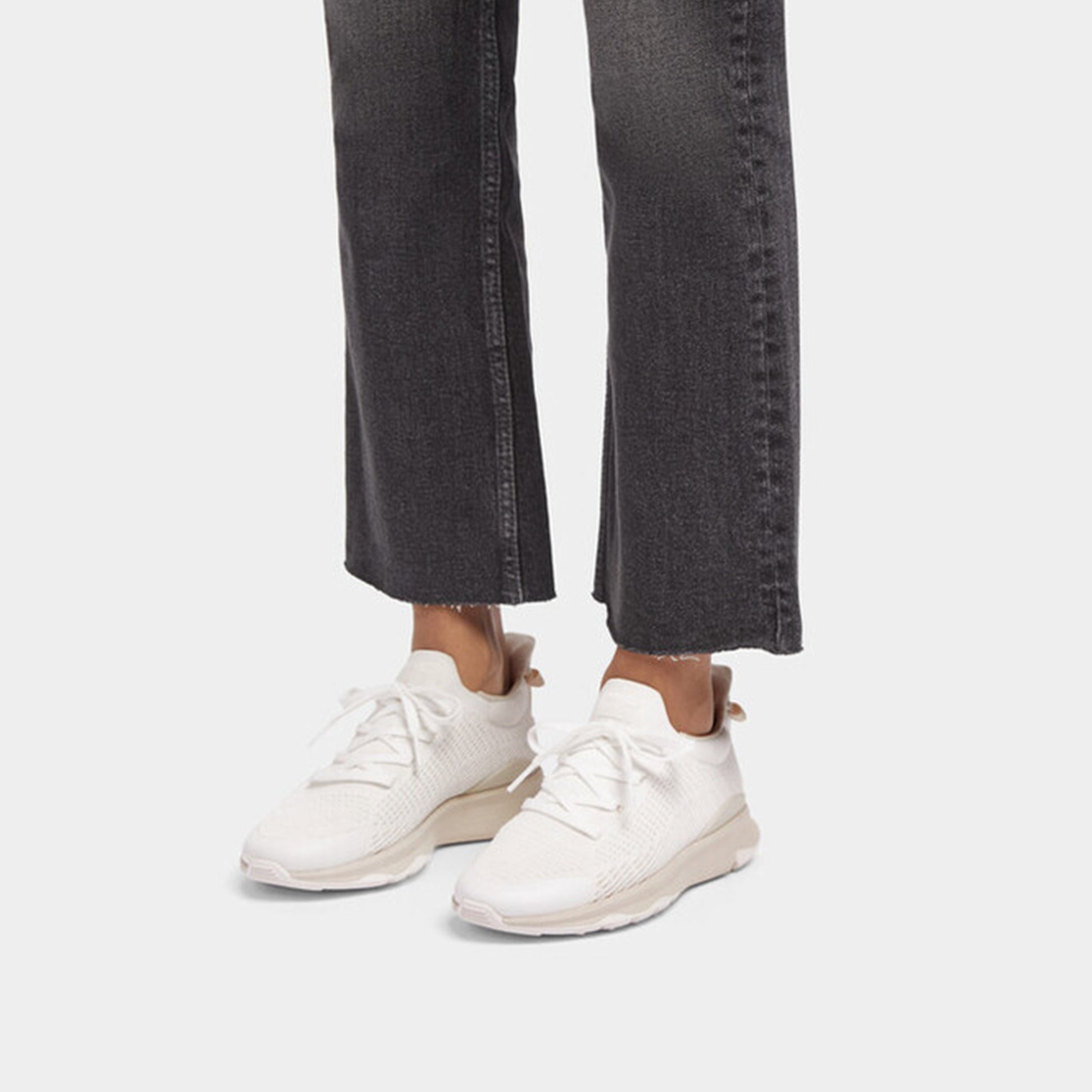 FitFlop VITAMIN FFX KNIT Womens Trainers Urban White/Paris Beige side view worn with black jeans.