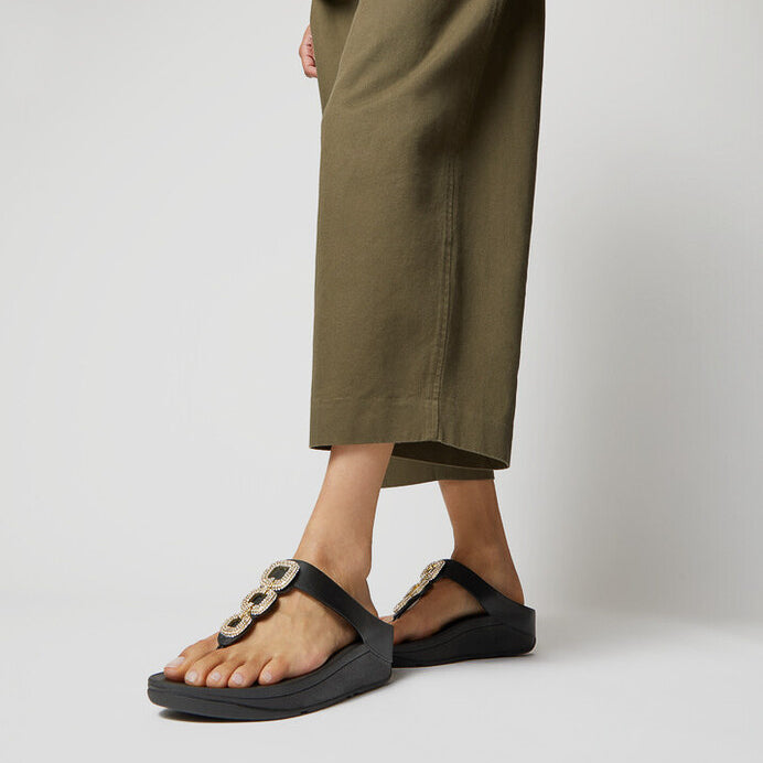 FitFlop FINO CRYSTAL-CHAIN Womens Toe Post Sandals Black side view worn with casual pants